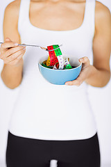 Image showing woman hands holding bowl with measuring tape