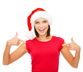 Image showing smiling woman in santa helper hat