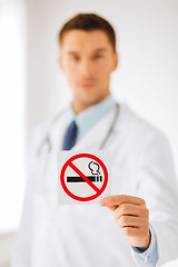 Image showing male doctor holding no smoking sign