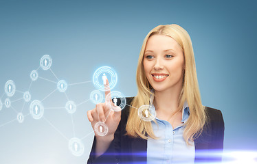 Image showing businesswoman pressing button with contact