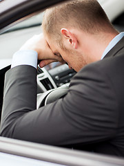 Image showing tired businessman or taxi car driver