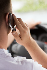 Image showing man using phone while driving the car