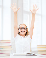 Image showing girl with books and hands up