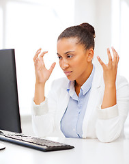 Image showing stressed african woman with computer