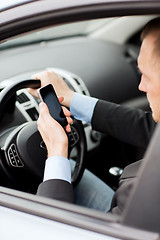 Image showing man using phone while driving the car