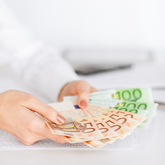 Image showing woman hands with euro cash money