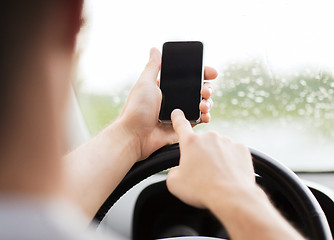 Image showing man using phone while driving the car