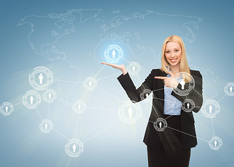 Image showing businesswoman pointing at contact icons