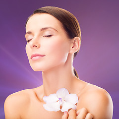Image showing relaxed woman with orhid flower