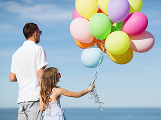 Image showing father and daughter with colorful balloons