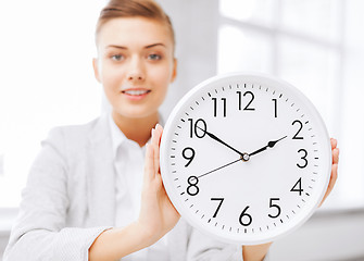 Image showing attractive businesswoman with white clock