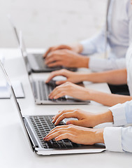 Image showing group of people working with laptops in office