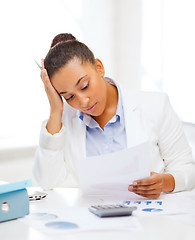 Image showing businesswoman working with calculator in office