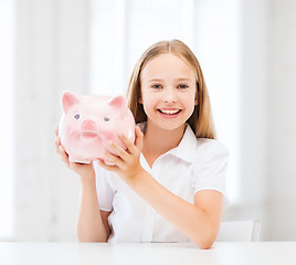 Image showing child with piggy bank