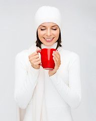 Image showing woman in hat with red tea or coffee mug