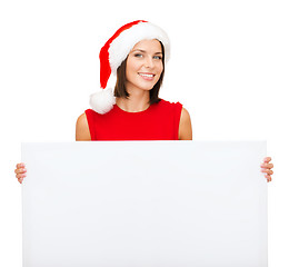 Image showing woman in santa helper hat with blank white board