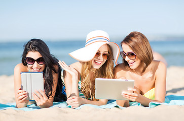 Image showing girls with tablet pc on the beach