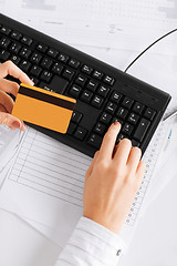 Image showing businesswoman with laptop using credit card