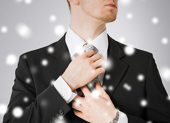 Image showing man adjusting his tie