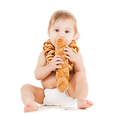 Image showing cute todler eating long bread