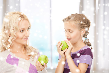 Image showing mother and daughter holding green apples