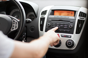 Image showing man using car audio stereo system