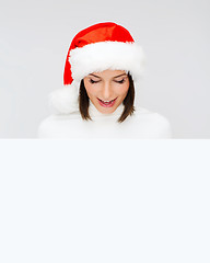 Image showing woman in santa helper hat with blank white board