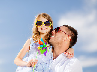 Image showing happy father and child in sunglasses over blue sky