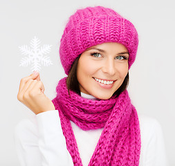 Image showing woman in hat and muffler with big snowflake