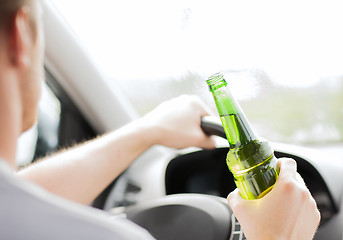 Image showing man drinking alcohol while driving the car