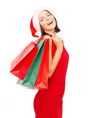 Image showing woman in red dress with shopping bags