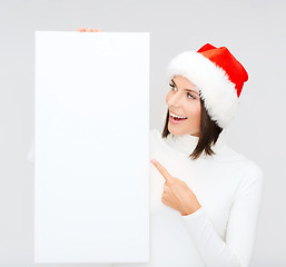 Image showing woman in santa helper hat with blank white board