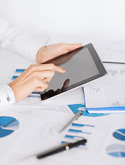 Image showing woman with tablet pc and chart papers