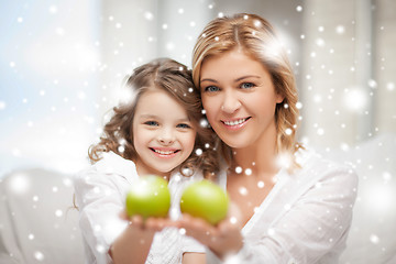 Image showing mother and daughter holding green apples