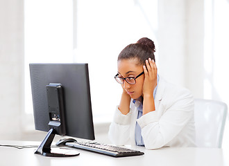 Image showing stressed african woman with computer