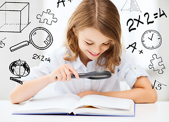 Image showing girl reading book with magnifier at school