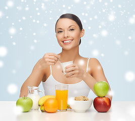 Image showing young woman eating healthy breakfast