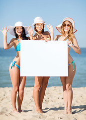 Image showing girls with blank board on the beach