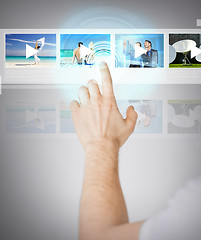 Image showing man pressing button on virtual screen