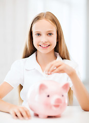 Image showing child with piggy bank