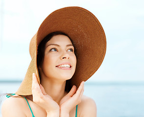 Image showing girl in hat standing on the beach