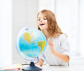 Image showing student girl with globe at school