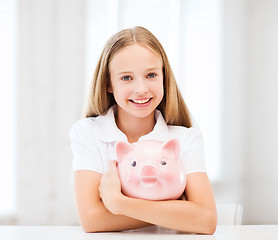 Image showing child with piggy bank