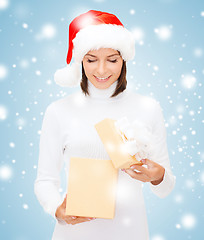 Image showing smiling woman in santa helper hat with gift box