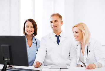 Image showing doctors looking at computer on meeting