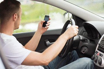 Image showing man using phone while driving the car