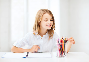 Image showing girl drawing with pencils at school