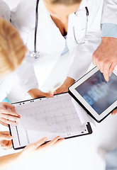 Image showing group of doctors looking at x-ray on tablet pc