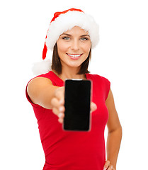 Image showing woman in santa helper hat with smartphone