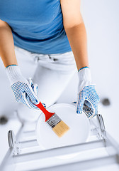 Image showing woman with paintbrush and paint pot